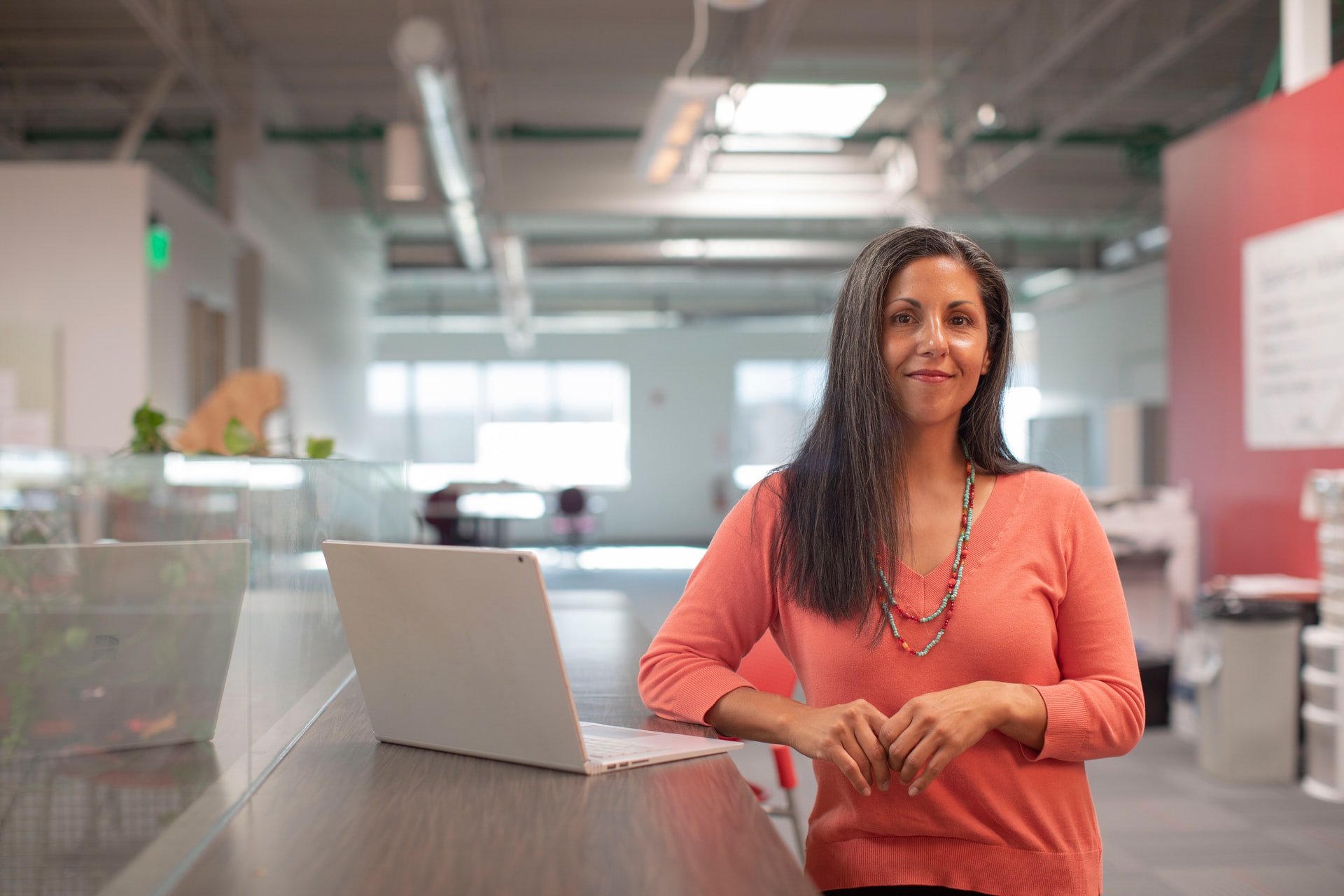 woman looking at camera working at standing desk